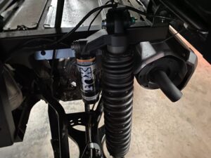 Close-up of a motorcycle suspension with a visible shock absorber and spring.