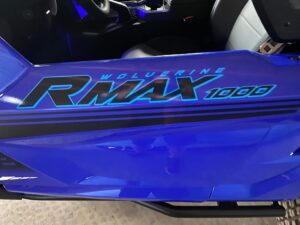 Close-up of blue Yamaha RMAX 1000 side panel with logo.