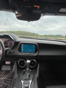 View from inside a car showing the dashboard and GPS screen.
