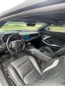 Interior view of a modern car showing the dashboard and front seats.