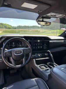 Interior view of a modern GMC vehicle showing the dashboard and steering wheel.