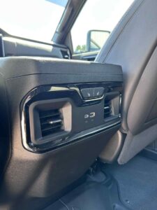 USB and power ports on the back of a vehicle's center console.