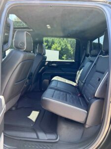 Interior view of a vehicle's rear leather seating and front seats.