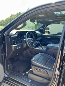 Interior view of a modern black car showcasing leather seats and advanced dashboard.
