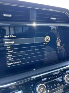 Car screen showing massage options for back and shoulders.
