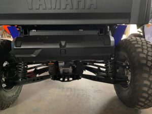 Close-up of a vehicle's suspension and steering mechanism.