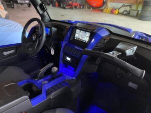 Car interior with blue ambient lighting and modern dashboard.